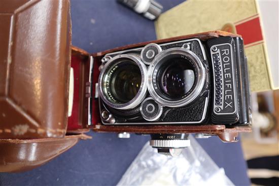 A Rolleiflex DBP DBGM 2.8f double lens camera, with original leather case and box, instructions and bag of accessories